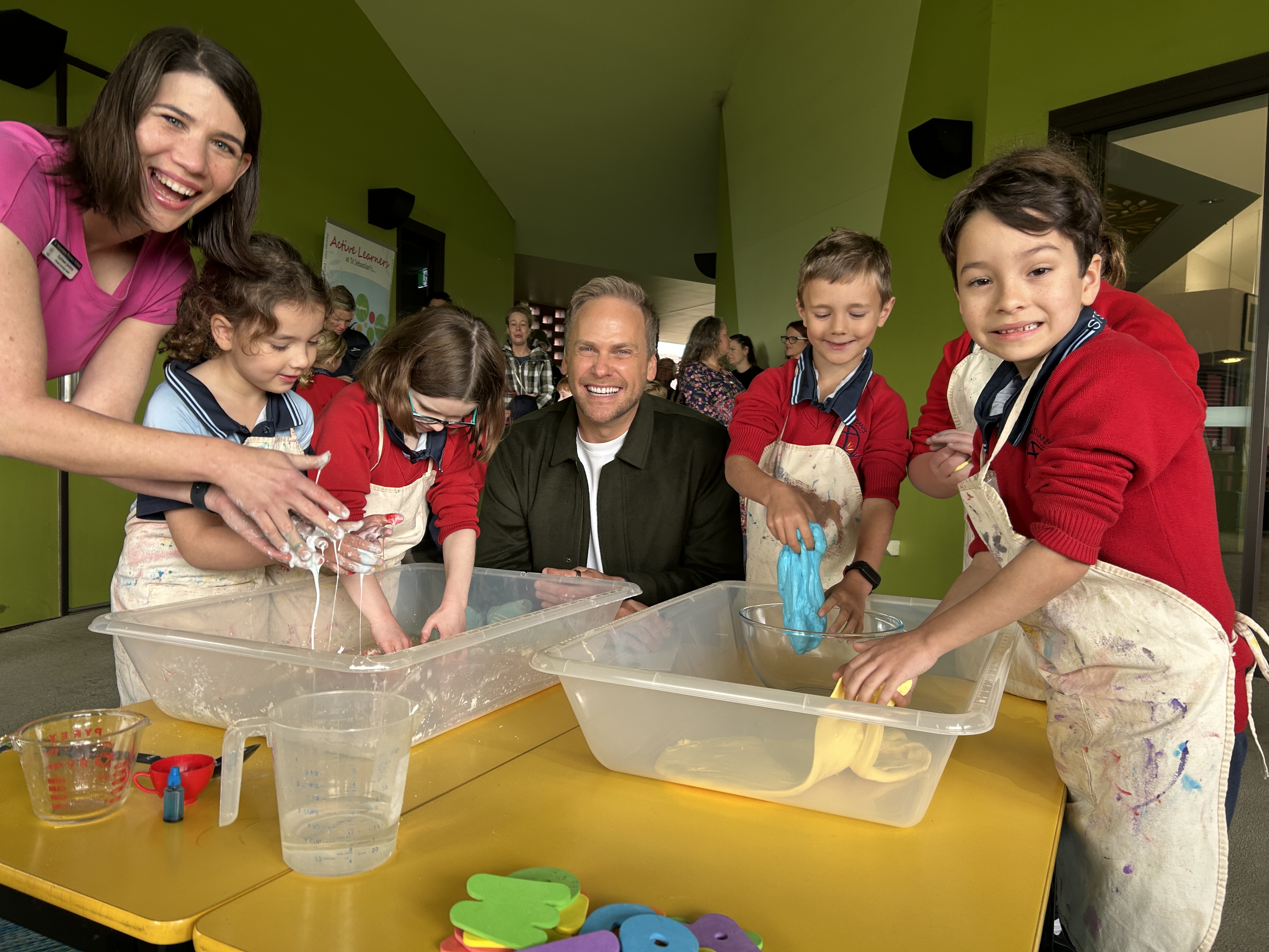 Students participating in a hands‑on classroom activity with adult support.