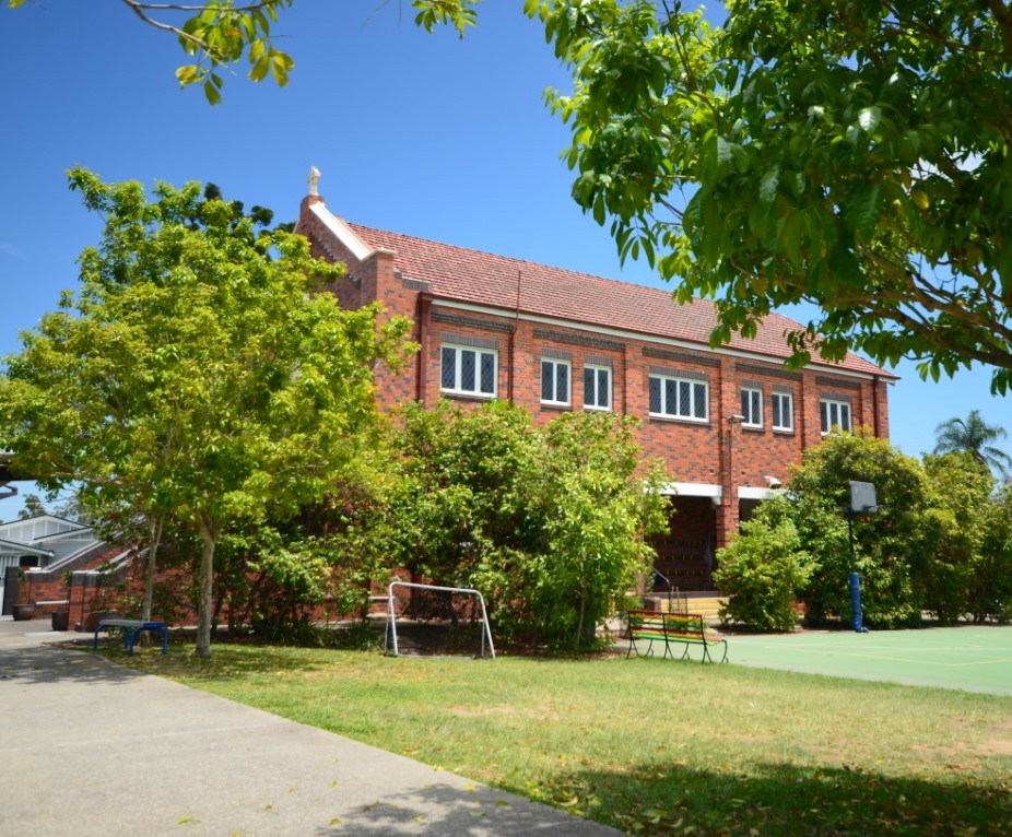 Brick school building and surrounding grounds.